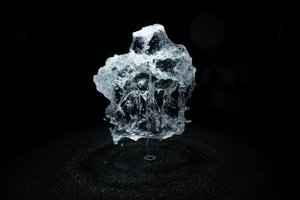 A round shower of water is frozen in mid air by strobe lighting.