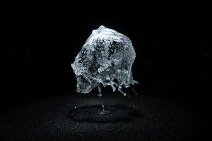 A round shower of water is frozen in mid air by strobe lighting.