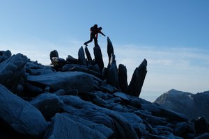 Chris crosses a series of tall rocks pointing straight up in the air like crystals.